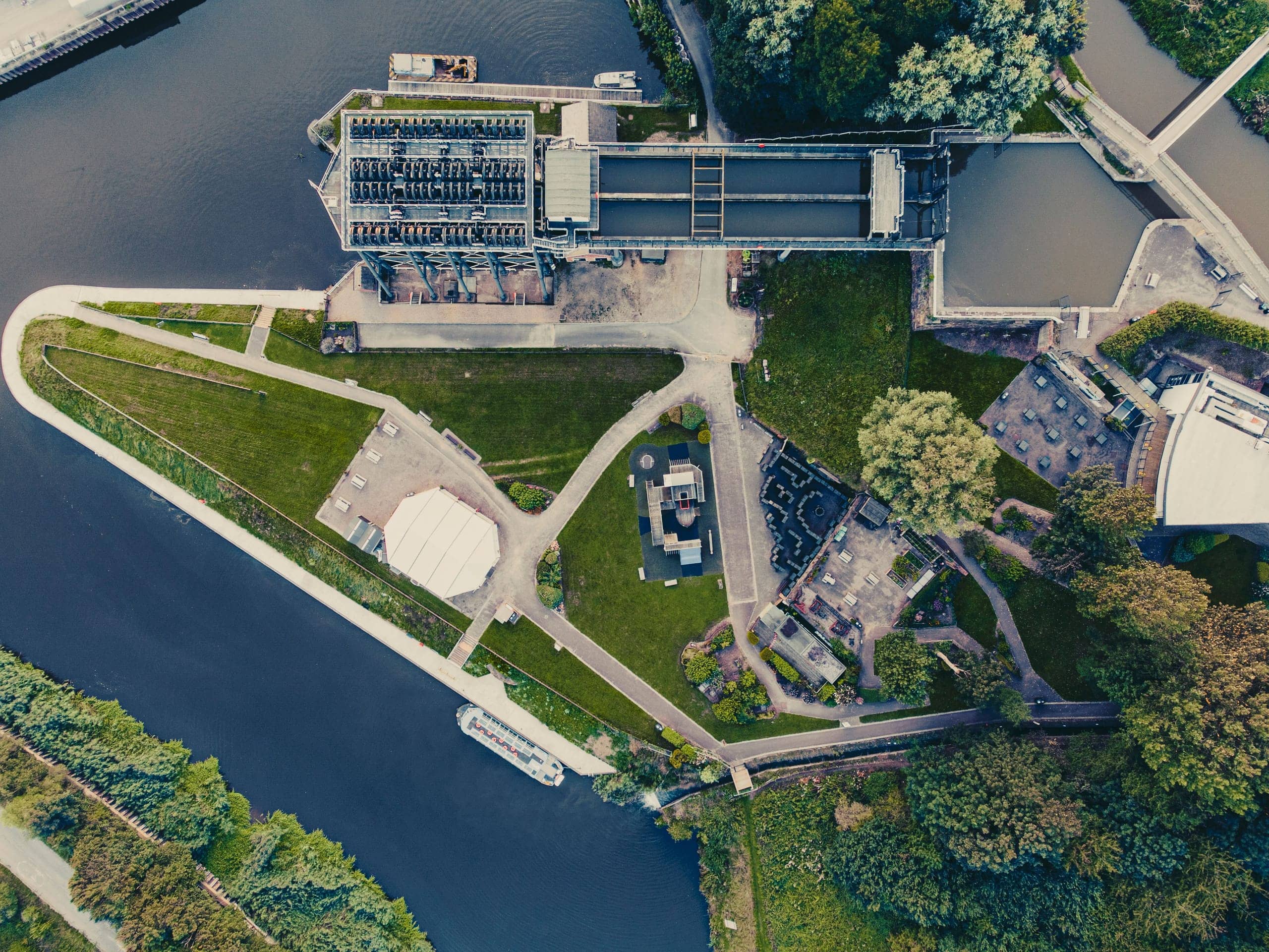 Aerial view of a riverside water and utility infrastructure complex