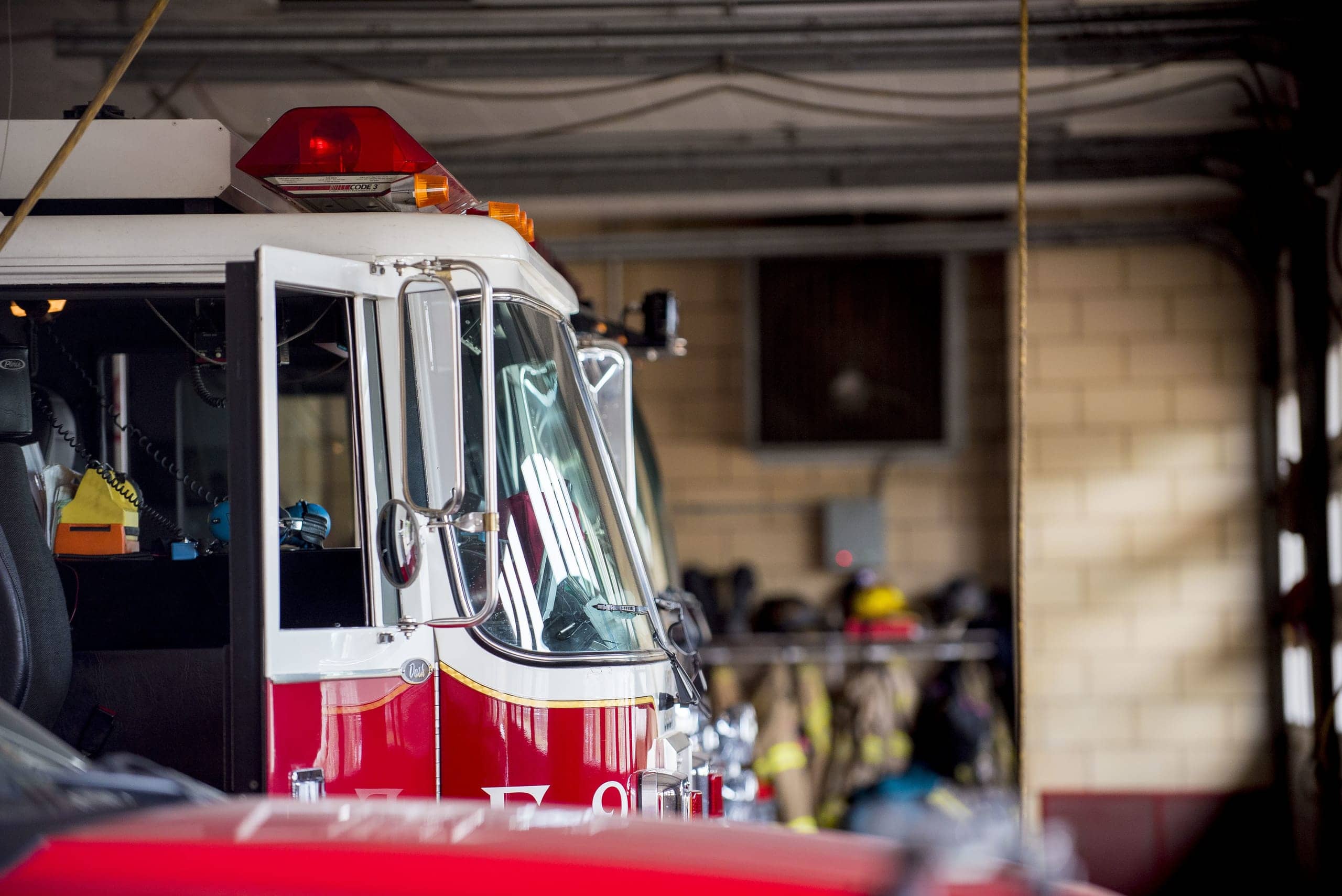 Firetruck parked inside a fire station garage