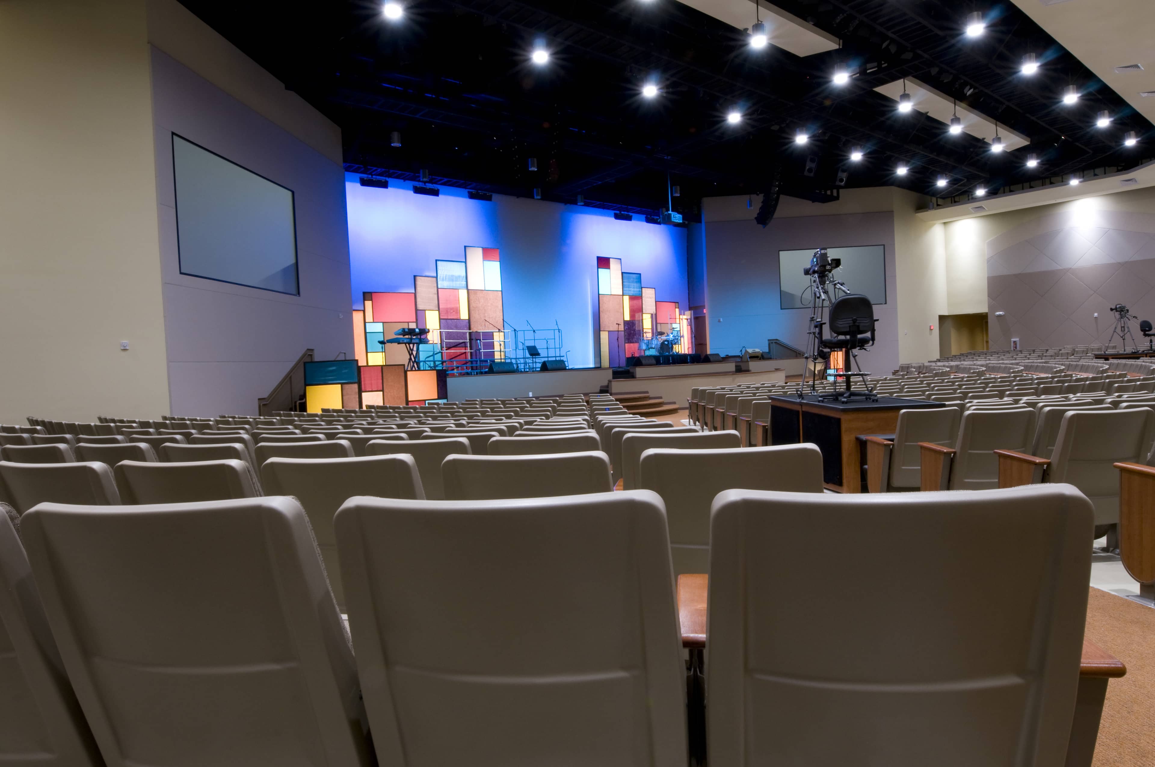 Rows of seats facing the stage inside a modern church auditorium