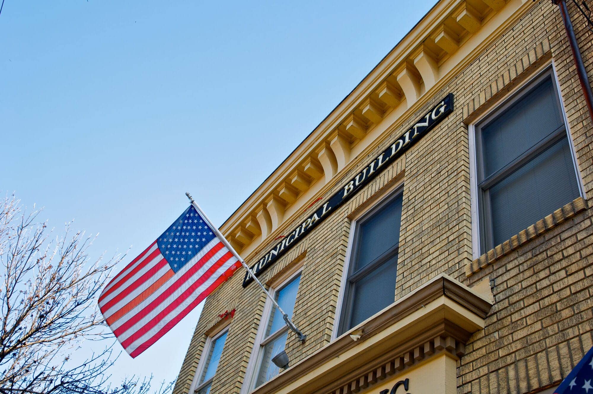 Municipal building exterior with a U.S. flag