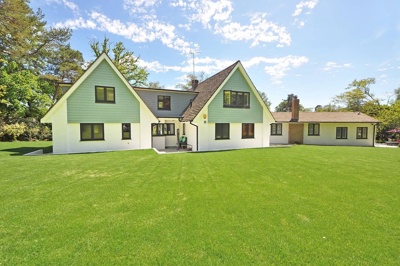 High-value family home with a manicured lawn on a clear day